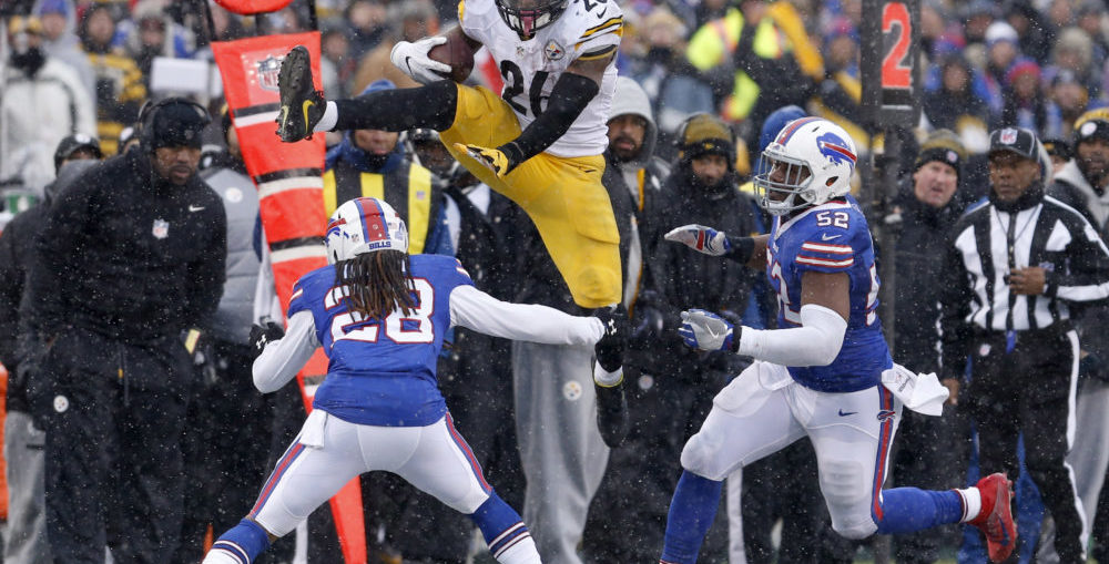 Pittsburgh Steelers running back Le'Veon Bell (26) runs the ball and tries to jump over Buffalo Bills cornerback Ronald Darby (28)